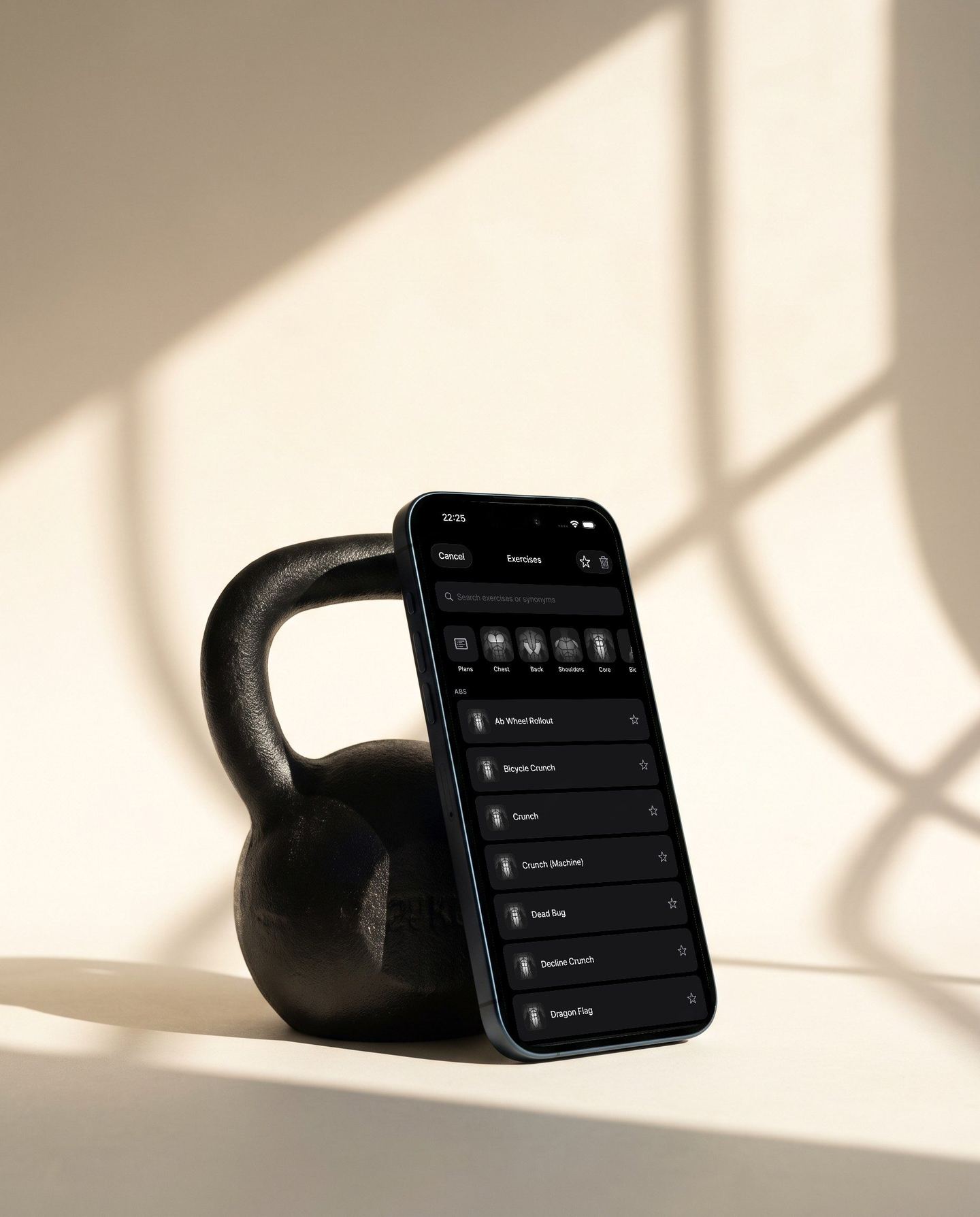 Reps exercise library on a phone leaning against a kettlebell in morning light