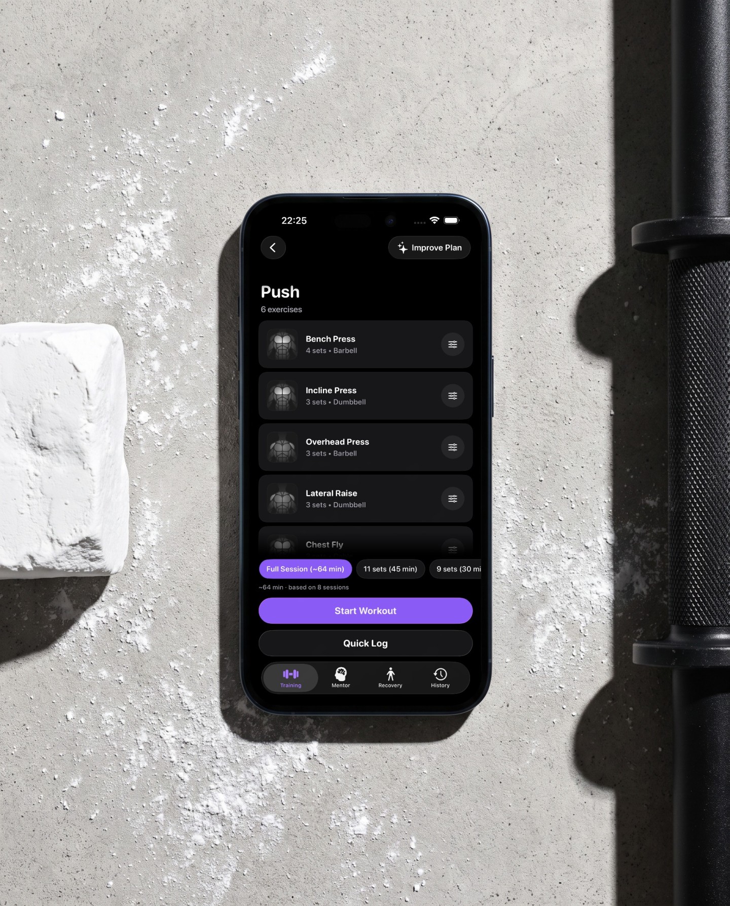 Reps routine before the start on a phone lying on chalk dusted concrete showing Push with six exercises and the time budget chips full session, 45 and 30 minutes