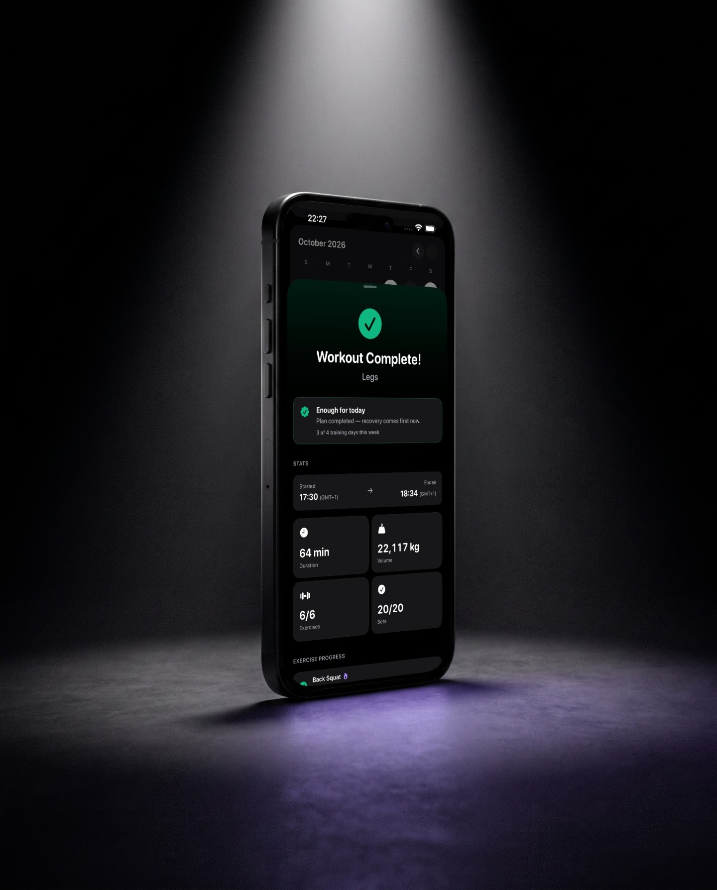 Reps workout summary on a phone lying on black stone in a beam of light showing workout complete, 64 minutes, six of six exercises